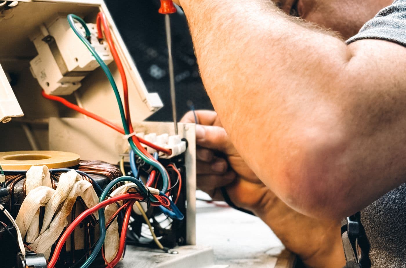 Electrician terminating cable during a wiring job in Surat