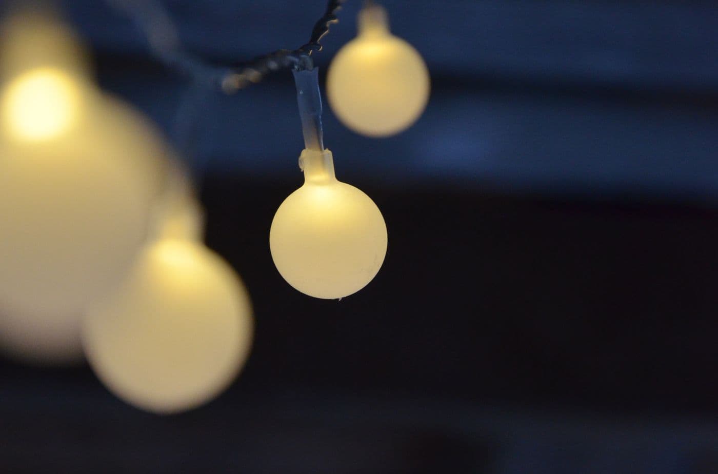 Warm outdoor lighting strung above a coastal setting near Dumas, Surat