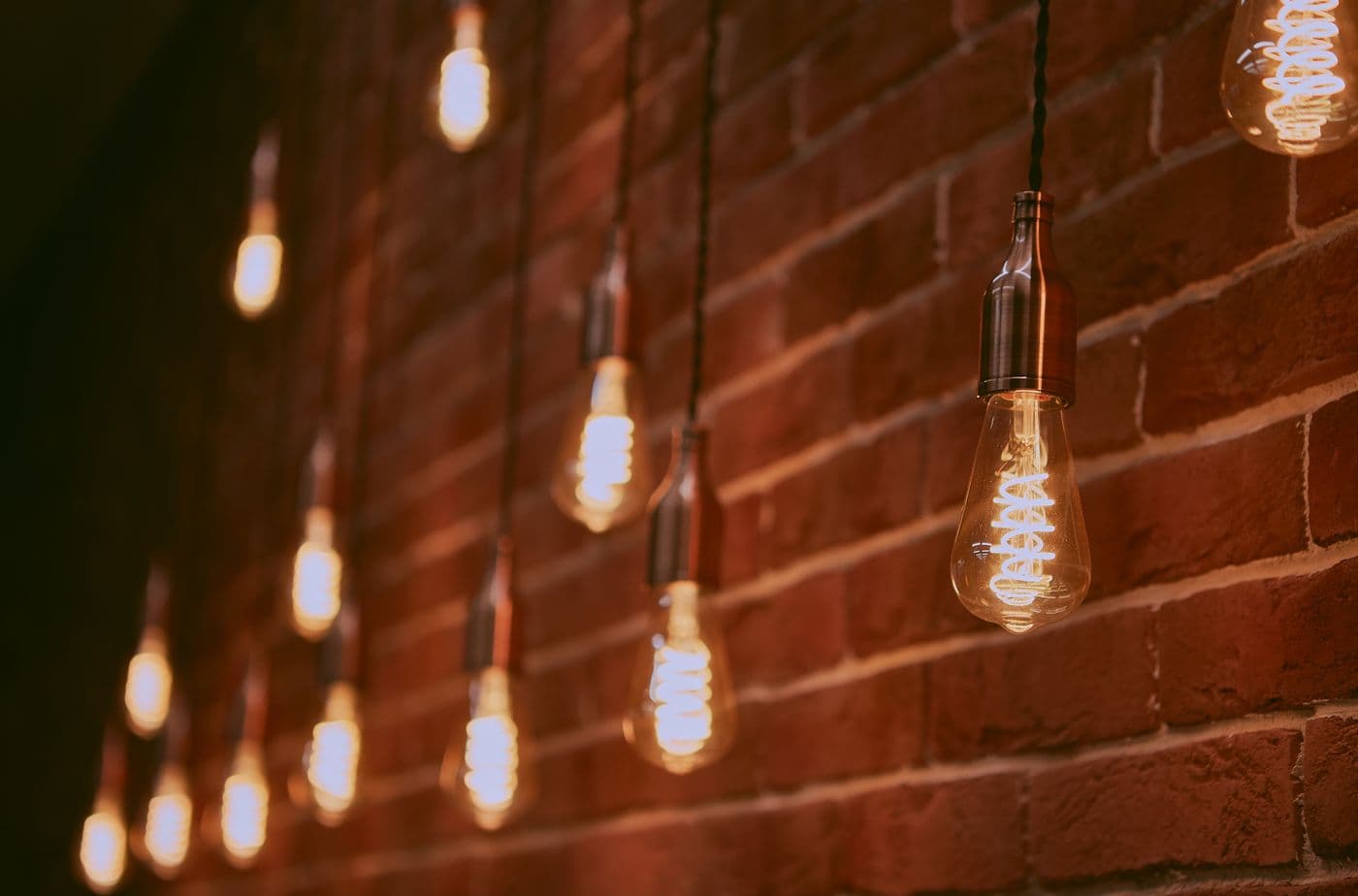 Row of warm hanging pendant bulbs providing ambient light