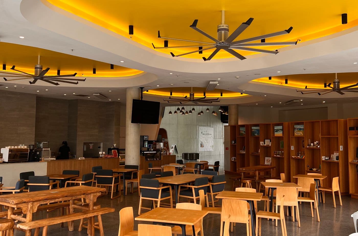 Ceiling fans installed across a bright open hall interior