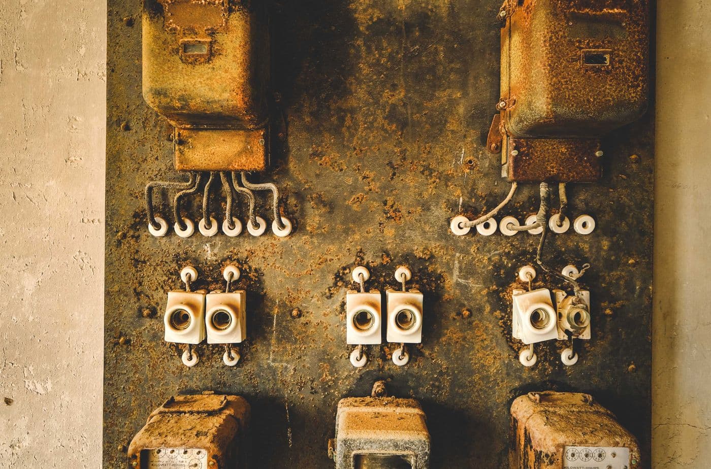 Old electrical sockets and wiring on a weathered wall