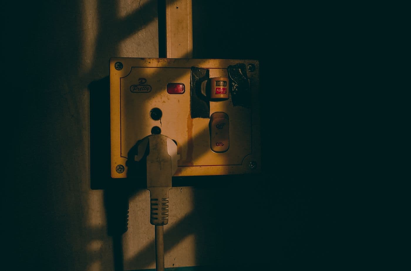 Wall socket outlet mounted on a dark painted interior wall