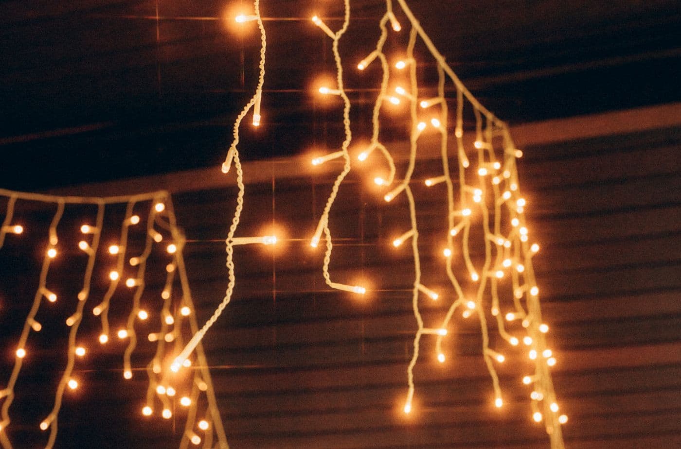 Warm string lights strung along a wall creating soft ambient lighting