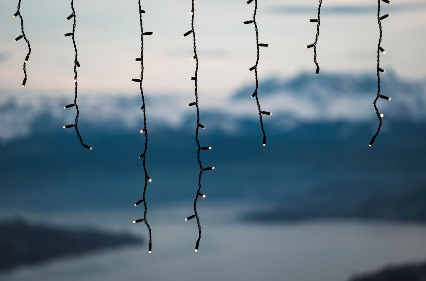 Hanging curtain-style festive lights along the edge of a building