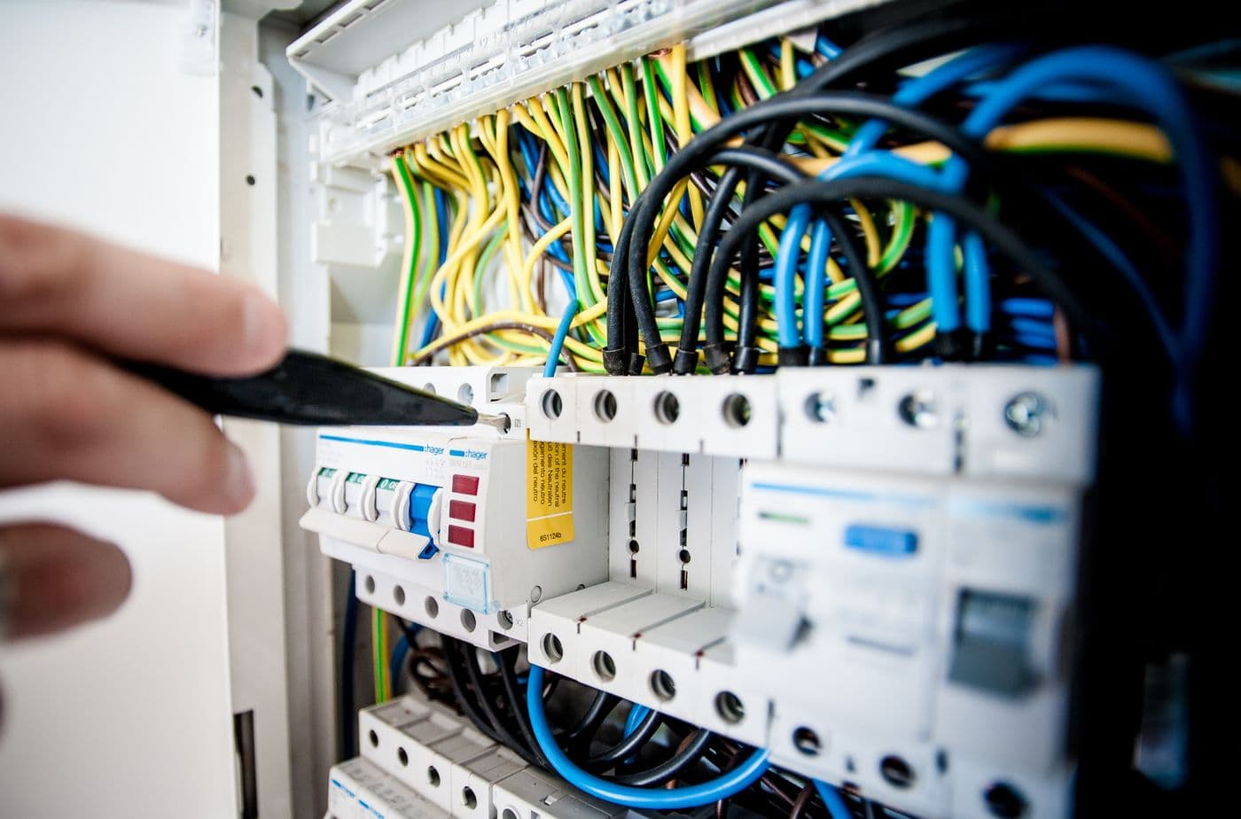 Hand resetting a miniature circuit breaker inside a residential distribution board